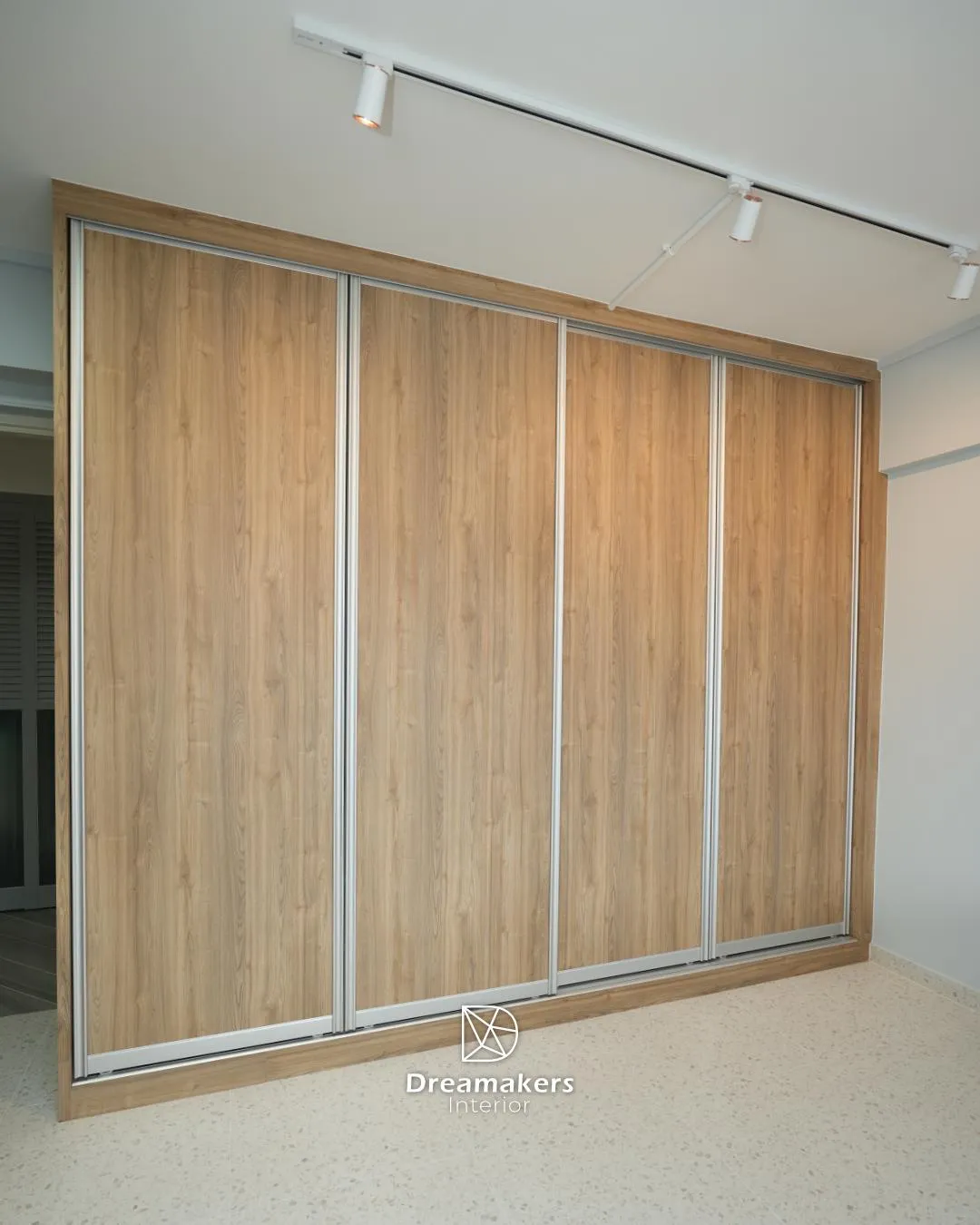 Full-wall oak sliding wardrobe over the original terrazzo flooring, Tampines executive apartment resale bedroom