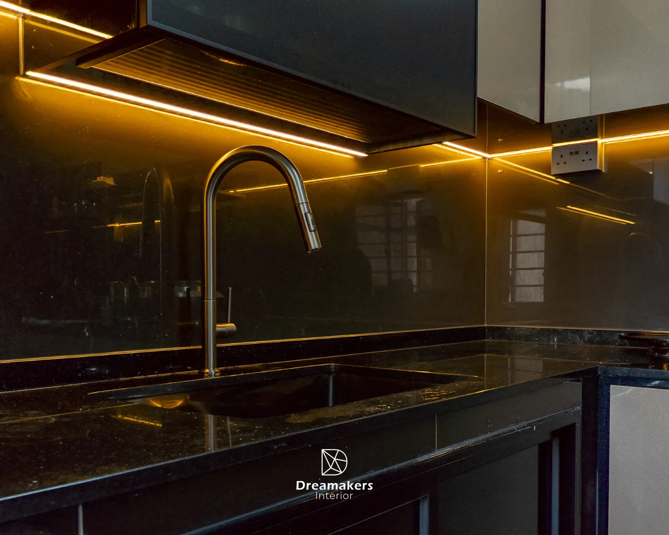 Black kitchen worktop with tinted glass backsplash and warm LED strip lighting, Telok Blangah 5-room resale kitchen
