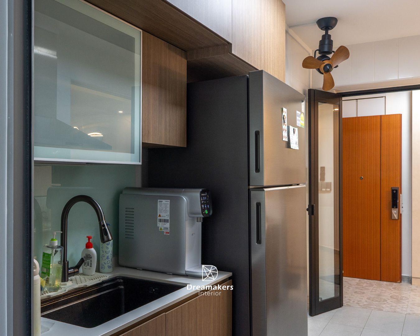 Kitchen sink area with glass-front cabinet and black accent panel, Chai Chee renovation