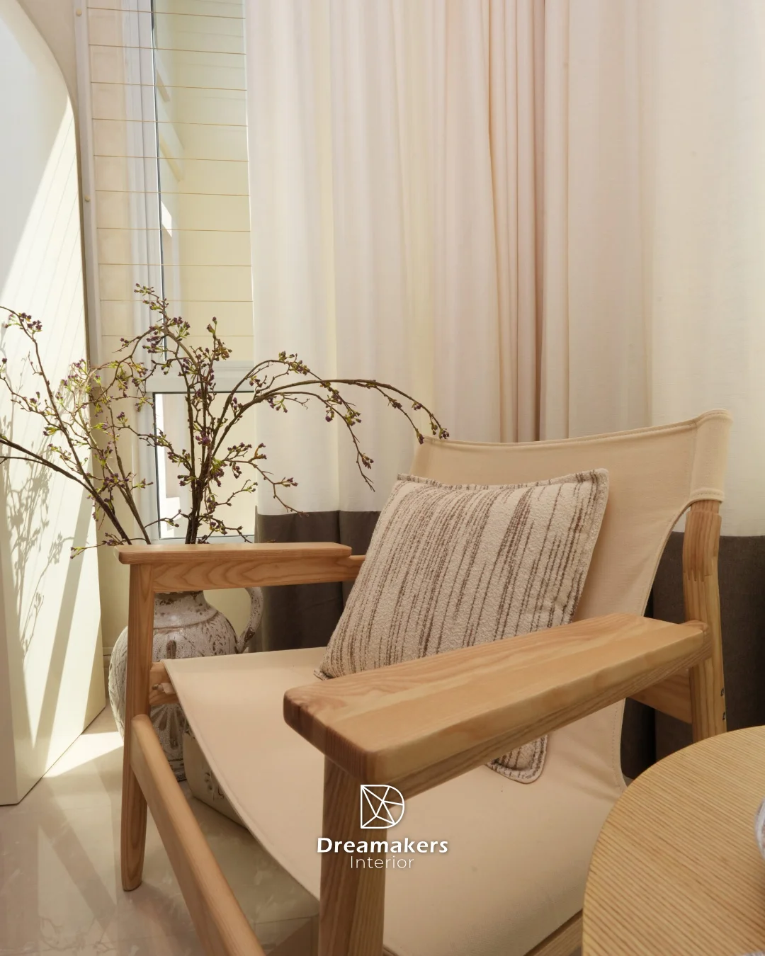 Ash wood armchair with boucle cushion beside sheer curtains, Duchess condo interior design Singapore