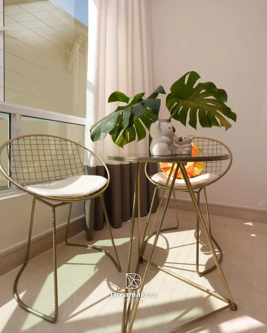 Gold wire bistro chairs and monstera by the window, Duchess condo interior design Singapore