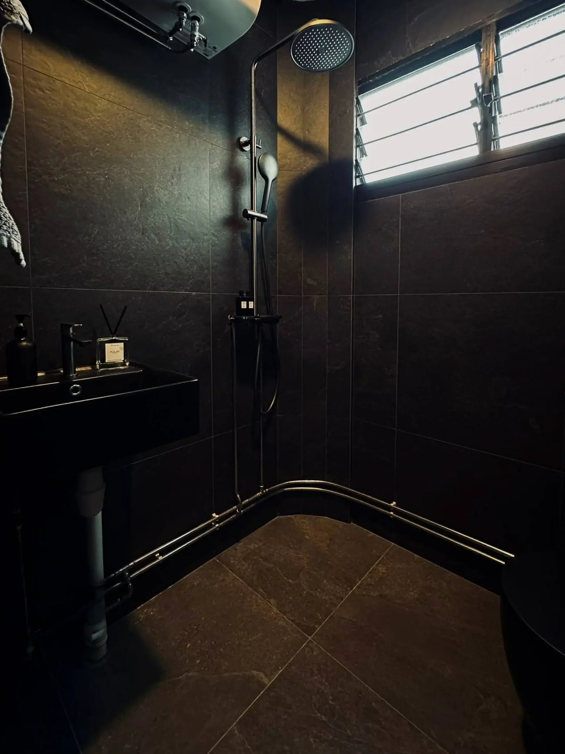 Common bathroom in dark slate-look tiles with rain shower and louvre window, Hougang 4-room resale flat