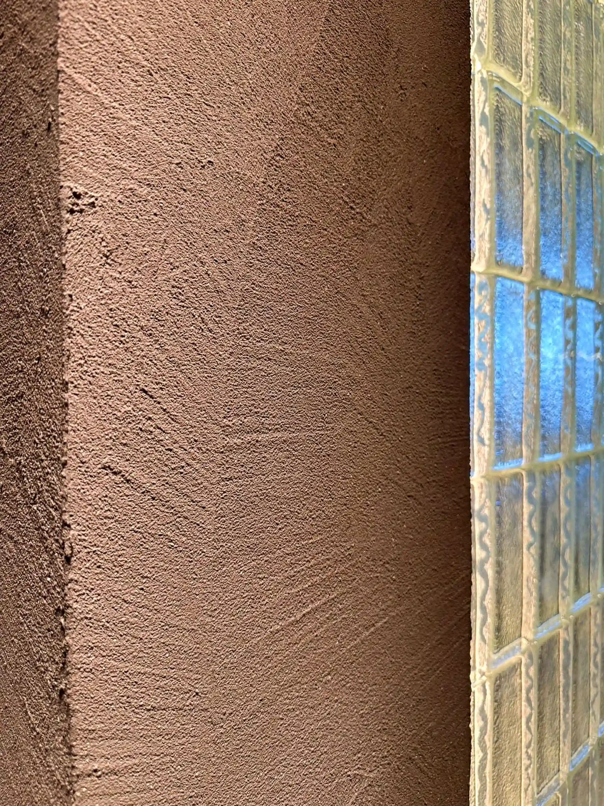 Hand-trowelled clay textured wall beside the backlit glass-block partition, Hougang 4-room resale renovation