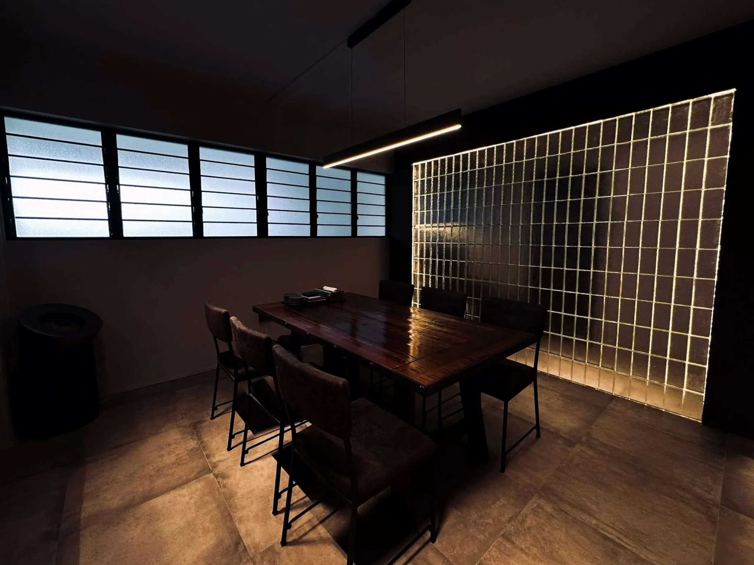 Dining area with reclaimed wood table and backlit glass-block feature wall in a 4-room resale renovation at 332 Hougang Ave 5
