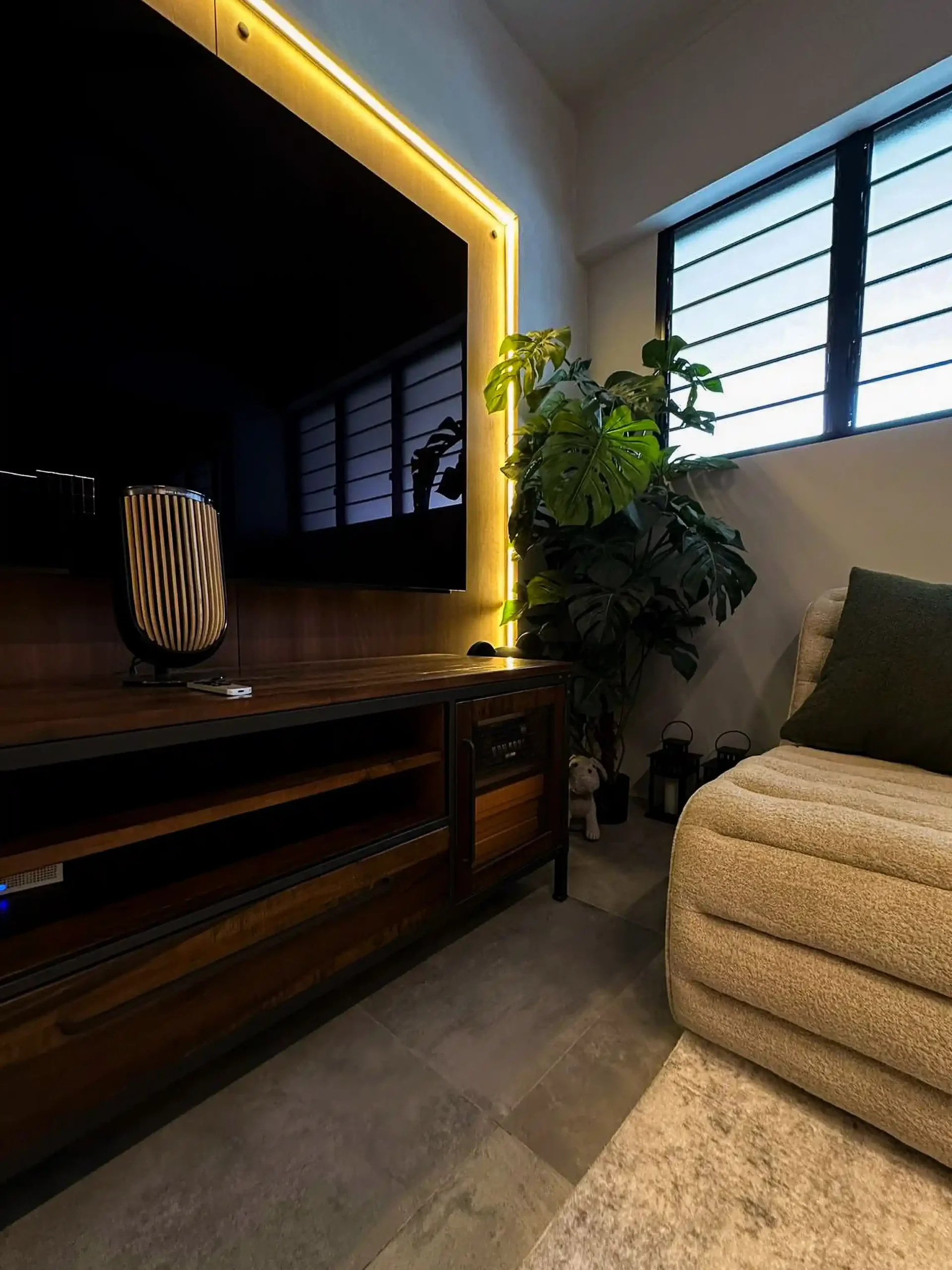 TV framed in a warm LED halo above the industrial wood-and-steel console, Hougang 4-room resale renovation