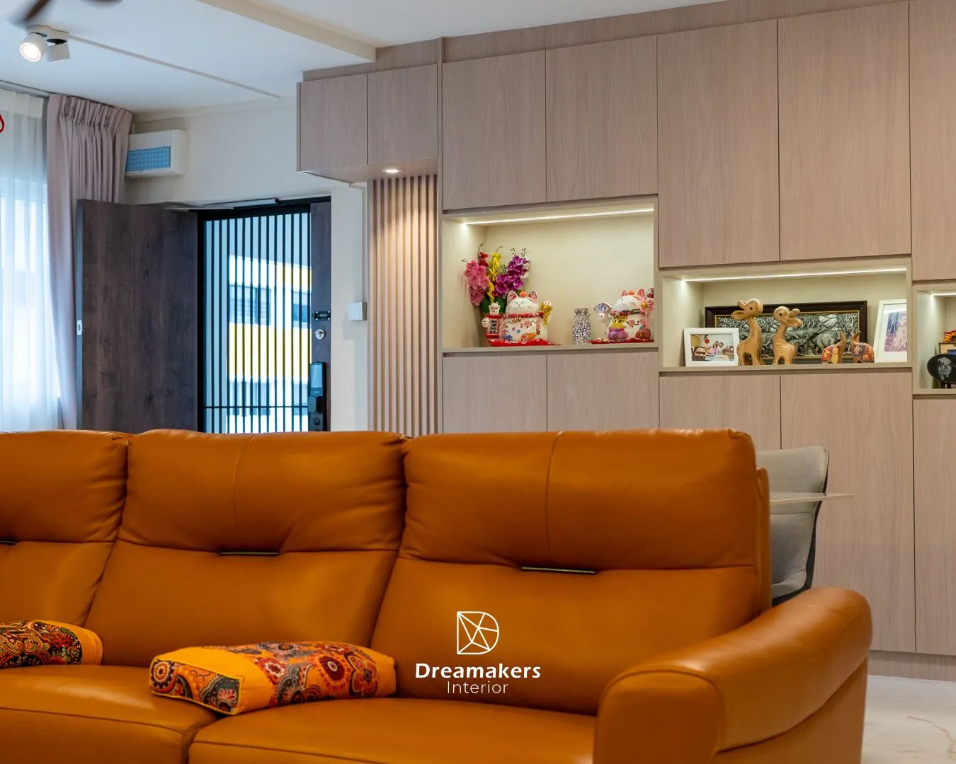 Living room with tan leather sofa and full-height cabinets with backlit display niches, 746 Jurong West 5-room resale renovation