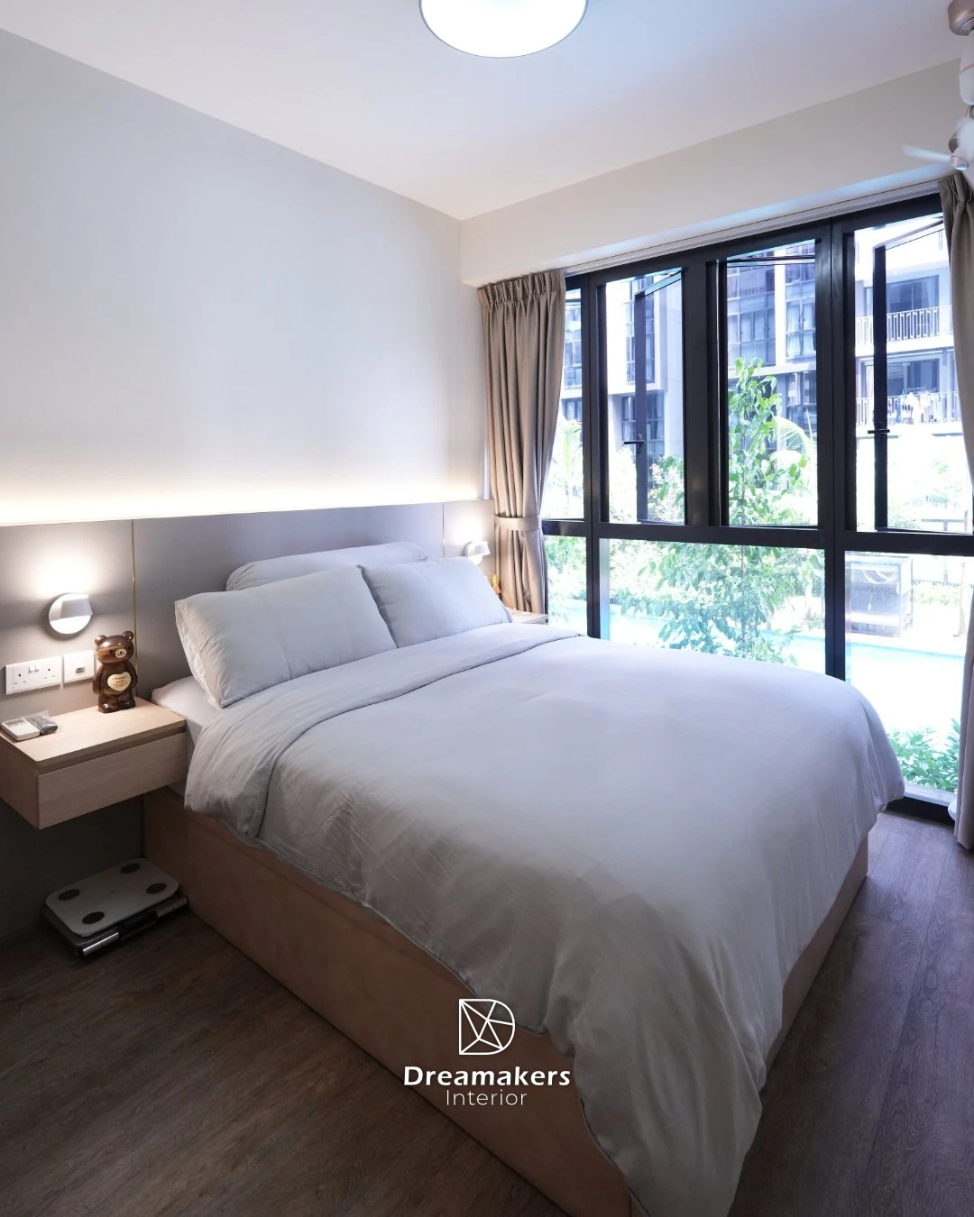 Master bedroom with cove lighting and greenery view through black-framed windows, Parc Canberra Sembawang