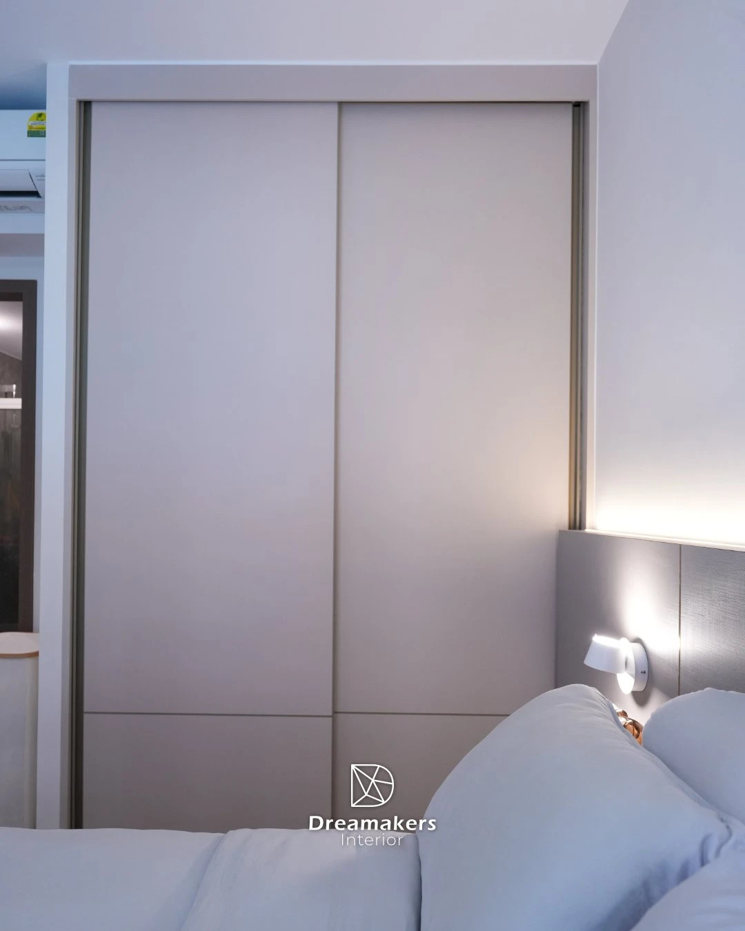 Master bedroom with full-height sliding-door wardrobe and bedside reading light, Parc Canberra executive condo