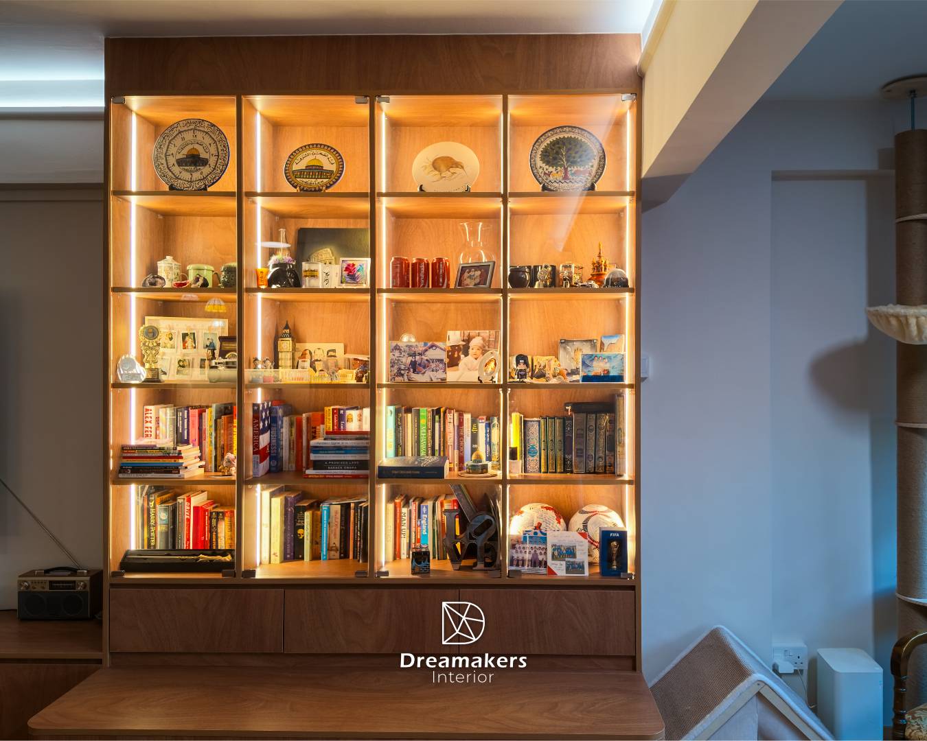 Backlit display shelves with the family's plates, books and keepsakes, Tampines executive apartment living room