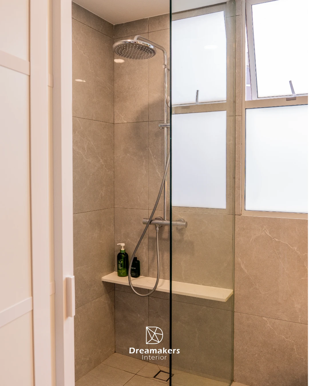 Stone-look bathroom with rain shower and glass screen, The Eden condo renovation