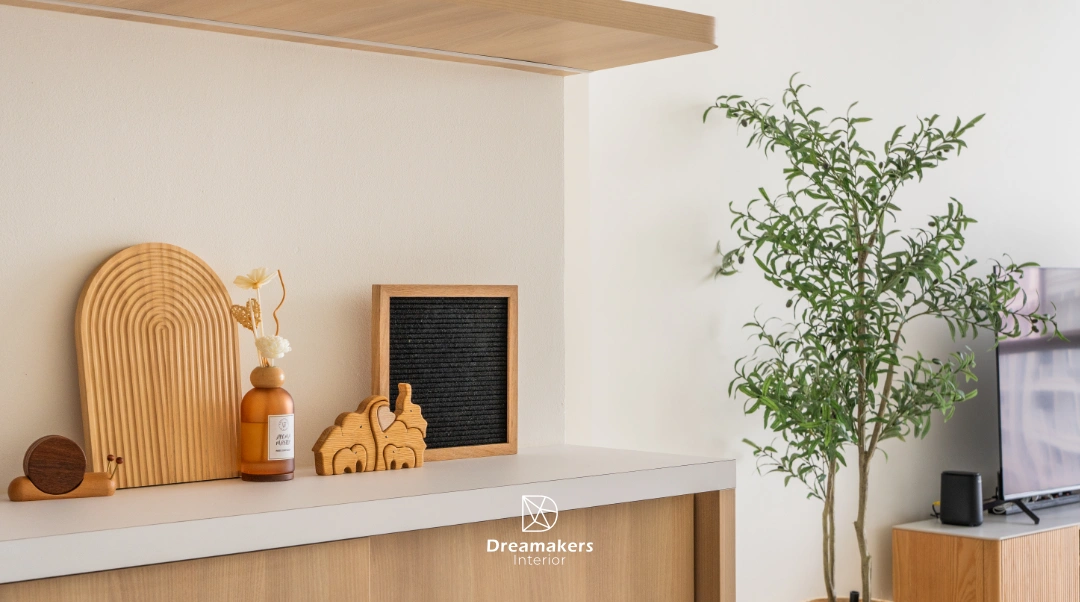 Warm japandi living room with oak display ledge and wooden keepsakes in a condo interior design at The Eden, Draycott Park