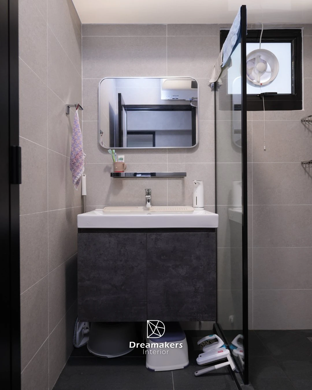 Bathroom with grey stone-look tiles, concrete-look vanity and black-framed shower screen, Woodleigh Link HDB